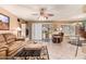 Bright living room with tile floors, a ceiling fan, sliding door and comfortable seating at 19093 N 97Th Ln, Peoria, AZ 85382