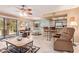 Cozy living room and dining area with tile floors, ceiling fan, and bar seating at 19093 N 97Th Ln, Peoria, AZ 85382