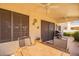 Covered patio area with ceiling fans and outdoor dining setup for relaxing entertainment at 19093 N 97Th Ln, Peoria, AZ 85382