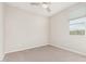 Neutral bedroom has plush carpeting, a ceiling fan and a window for natural light at 1997 E Brooklyn Dr, Casa Grande, AZ 85122