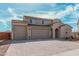 Charming two-story home featuring a three-car garage, desert landscaping and a paver driveway at 1997 E Brooklyn Dr, Casa Grande, AZ 85122