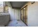 A balcony with a white railing, concrete floor, white door and sliding glass door at 2025 E Campbell Ave # 265, Phoenix, AZ 85016