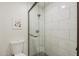 Bathroom with glass enclosed tiled shower, toilet, and decorative art at 2025 E Campbell Ave # 265, Phoenix, AZ 85016