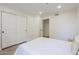 Bedroom featuring a bright window, large closets, and light colored vinyl flooring at 2025 E Campbell Ave # 265, Phoenix, AZ 85016