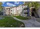 Condominium building exterior featuring stone accents and well-maintained landscaping in a lush, green setting at 2025 E Campbell Ave # 265, Phoenix, AZ 85016