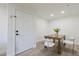 Bright dining area featuring neutral walls, wood flooring, and a modern dining set with clean, white chairs at 2025 E Campbell Ave # 265, Phoenix, AZ 85016