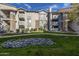 Multi-story apartment building with grey paint, stone accents, balconies, and landscaped grounds at 2025 E Campbell Ave # 265, Phoenix, AZ 85016