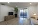 Living room with sliding glass doors, modern decor, sleek furniture, and ample natural light at 2025 E Campbell Ave # 265, Phoenix, AZ 85016