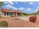 Charming backyard with a paved patio, lush greenery, and colorful flowers creates a serene outdoor space at 20603 N Stonegate Dr, Sun City West, AZ 85375