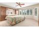 Bedroom with carpet flooring, a ceiling fan, and window with shutters overlooking the front yard at 20603 N Stonegate Dr, Sun City West, AZ 85375