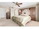 Cozy bedroom featuring built-in storage, a ceiling fan, and neutral carpet at 20603 N Stonegate Dr, Sun City West, AZ 85375