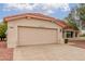 Attached two-car garage with a paved driveway offers convenience and ample parking space at 20603 N Stonegate Dr, Sun City West, AZ 85375