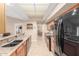 Well-lit kitchen with granite countertops, wooden cabinets, and modern appliances at 20603 N Stonegate Dr, Sun City West, AZ 85375