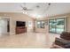 Relaxing living room with tiled floors, natural light, and comfortable seating area at 20603 N Stonegate Dr, Sun City West, AZ 85375