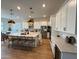 Modern kitchen with island, stainless steel appliances, white cabinets, and a dining area, creating an inviting space at 22703 E Alyssa Rd, Queen Creek, AZ 85142