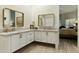 Bathroom featuring dual vanities, framed mirrors, and white cabinets at 25409 N Ranch Gate Rd, Scottsdale, AZ 85255