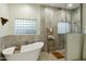 Modern bathroom features a soaking tub, glass-enclosed shower, and stylish fixtures at 25409 N Ranch Gate Rd, Scottsdale, AZ 85255