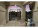 Outdoor seating area with decorative metal entry gate, tile flooring, and colorful throw pillows at 25409 N Ranch Gate Rd, Scottsdale, AZ 85255