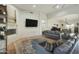 Open-concept living room features a fireplace and flows into the dining area with tile floors at 25409 N Ranch Gate Rd, Scottsdale, AZ 85255