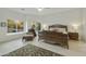 Bright main bedroom with large windows showcasing outside greenery and a sitting area at 25409 N Ranch Gate Rd, Scottsdale, AZ 85255