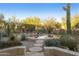 Inviting pool surrounded by desert landscaping, including native plants and cacti at 25409 N Ranch Gate Rd, Scottsdale, AZ 85255