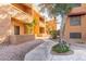 Exterior view of building with walkways, mature trees and foliage at 2625 E Indian School Rd # 240, Phoenix, AZ 85016