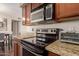 Close-up of a kitchen featuring granite countertops and modern stainless steel appliances at 2625 E Indian School Rd # 240, Phoenix, AZ 85016