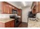 A kitchen showcasing granite countertops, rich wood cabinetry, and stainless steel appliances at 2625 E Indian School Rd # 240, Phoenix, AZ 85016