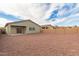 This backyard has gravel landscaping and a covered patio area off the back of the home at 274 W Kona Dr, Casa Grande, AZ 85122