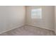 Empty bedroom with carpet flooring and large window at 274 W Kona Dr, Casa Grande, AZ 85122