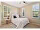 Bright bedroom with a white bed, neutral walls, and lots of natural light through bright windows at 29816 N 129Th Gln, Peoria, AZ 85383