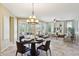 Stylish dining area with a modern chandelier and comfortable seating at 29816 N 129Th Gln, Peoria, AZ 85383