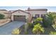 Charming single-story home with a well-manicured desert landscape, three car garage, and neutral stucco at 29816 N 129Th Gln, Peoria, AZ 85383