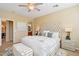 This lovely main bedroom features an upholstered headboard, soft decor, and lots of natural light at 29816 N 129Th Gln, Peoria, AZ 85383