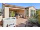 Backyard patio featuring a relaxing hot tub, comfortable seating area, and lush desert landscaping at 29816 N 129Th Gln, Peoria, AZ 85383