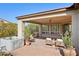 Backyard patio with a luxurious hot tub, outdoor seating, and an outdoor kitchen and BBQ area at 29816 N 129Th Gln, Peoria, AZ 85383