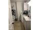 Well-lit bathroom featuring modern fixtures, white cabinetry, updated mirror, and neutral tiled flooring at 32628 N 163Rd Ave, Surprise, AZ 85387