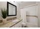 Beautiful bathroom with granite countertops, tiled shower and tub combination at 4241 E Montecito Ave, Phoenix, AZ 85018