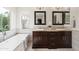 Elegant bathroom with dual vanities and a freestanding tub, offering a spa-like experience at 4241 E Montecito Ave, Phoenix, AZ 85018