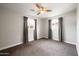 Bright bedroom with neutral walls, carpet flooring, ceiling fan and two windows at 4241 E Montecito Ave, Phoenix, AZ 85018