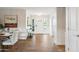 Bright foyer featuring wood-look floors, white wainscoting, modern lighting, and front door with sidelights at 4241 E Montecito Ave, Phoenix, AZ 85018