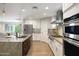 Modern kitchen featuring stainless steel appliances, gray subway tile backsplash, and light countertops at 4241 E Montecito Ave, Phoenix, AZ 85018