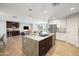 Open kitchen view with island, stainless steel appliances and view into the living area, promoting modern living and entertaining at 4241 E Montecito Ave, Phoenix, AZ 85018