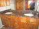 Bathroom vanity featuring double sinks, beautiful granite countertop, and custom natural wood cabinets at 4303 E Cactus Rd # 331, Phoenix, AZ 85032