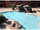 A sparkling pool featuring rock waterfall features and ample tanning deck at 4303 E Cactus Rd # 331, Phoenix, AZ 85032