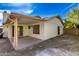 Exterior rear view of the home highlighting the backyard, covered patio, and perimeter fencing at 4436 W Morrow Dr, Glendale, AZ 85308