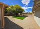 Large backyard with low-maintenance desert landscaping and a square of green grass at 4436 W Morrow Dr, Glendale, AZ 85308