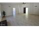 Bright, spacious living room featuring tile floors, high ceilings, and a modern ceiling fan at 4436 W Morrow Dr, Glendale, AZ 85308