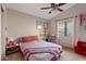 Bedroom with a pink accent bed frame and colorful decor, creating a fun and vibrant space at 4514 E Mazatzal Dr, Cave Creek, AZ 85331