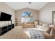 Bright living room with vaulted ceilings, a large window, and a comfortable sectional sofa at 4514 E Mazatzal Dr, Cave Creek, AZ 85331